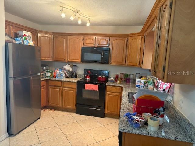 2108 Wolf Road Orlando, FL 32808 - Photo 4 of 14 a kitchen with stainless steel appliances granite countertop a refrigerator stove and sink