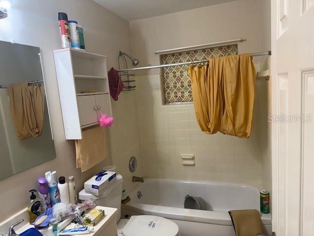 2108 Wolf Road Orlando, FL 32808 - Photo 9 of 14 a bathroom with a sink toilet and shower