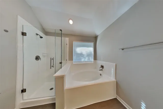 a bathroom with a bathtub and a shower