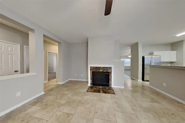 a view of a livingroom with a kitchen and a fireplace