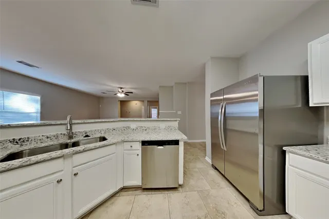 a kitchen with a sink and a refrigerator