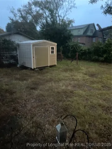 a backyard of a house with table and chairs