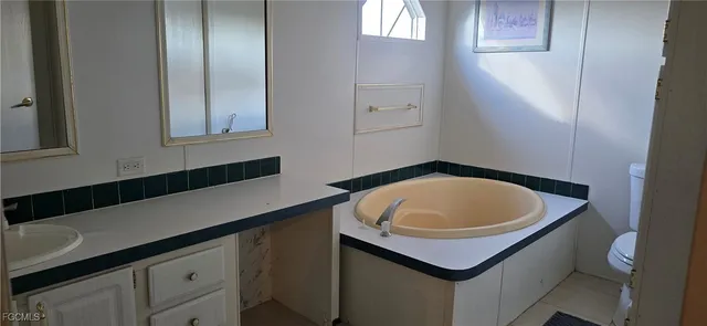 a bathroom with a toilet and a window