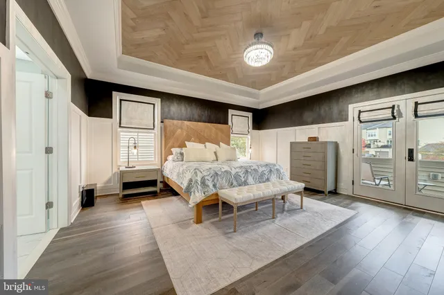 a spacious bedroom with a bed and wooden floor