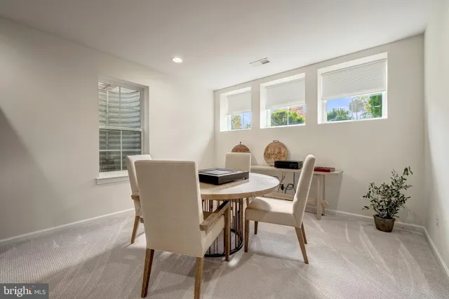 a view of a dining room with furniture and a window