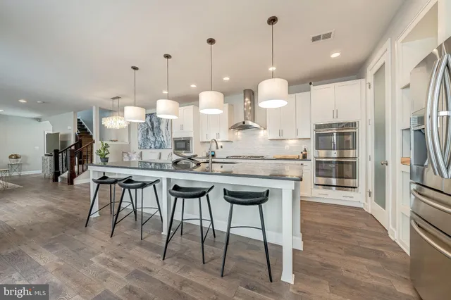 a large kitchen with a table and chairs