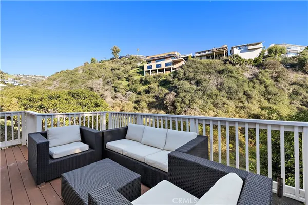 a view of a balcony with couches and wooden floor