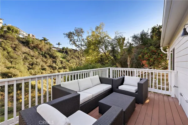 a balcony with wooden floor and fence