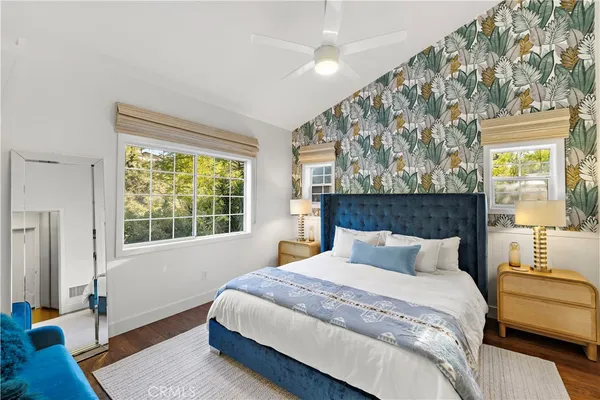 a bedroom with a large bed and a window