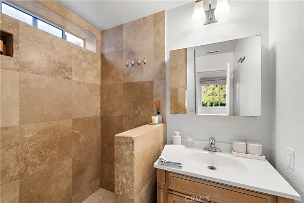 a bathroom with a sink toilet and shower