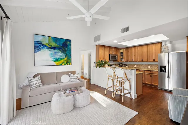 a living room with furniture and a kitchen view