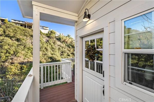 a view of a balcony with a floor to ceiling window with wooden floor