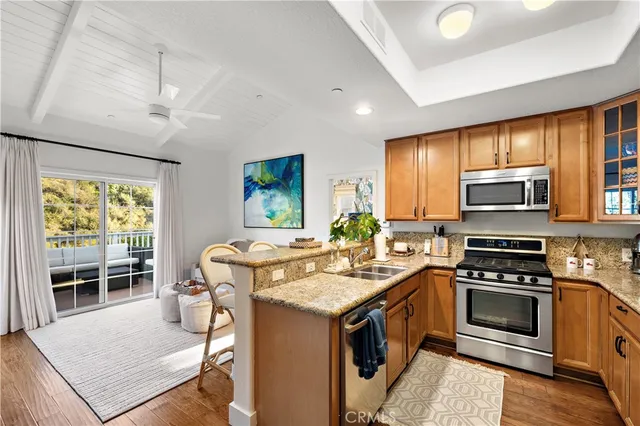 a kitchen with a stove a sink and a refrigerator