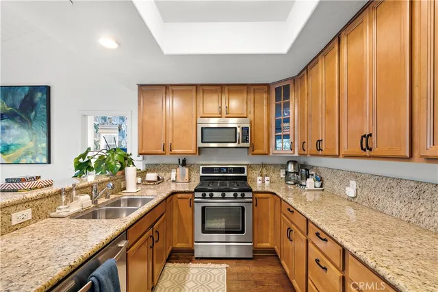 a kitchen with a stove a sink and a microwave