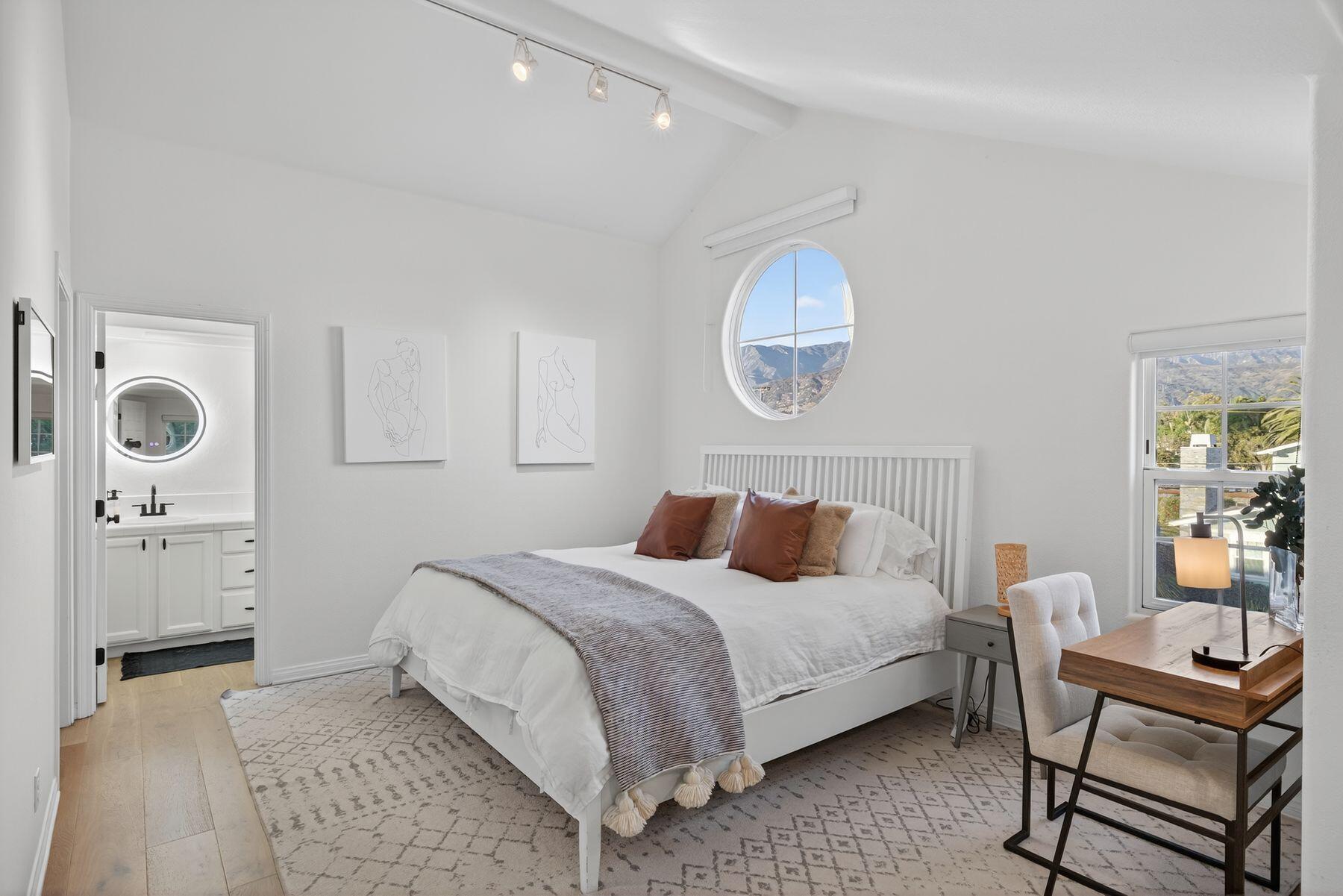 4731 4th Street Carpinteria, CA 93013 - Photo 13 of 30 a bedroom with a bed and a chandelier