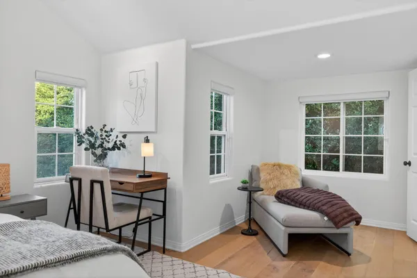a bedroom with a bed and wooden floor