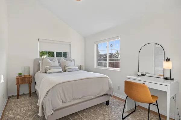 a bedroom with a bed a table and chair