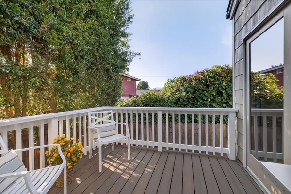 a view of balcony with wooden floor and fence