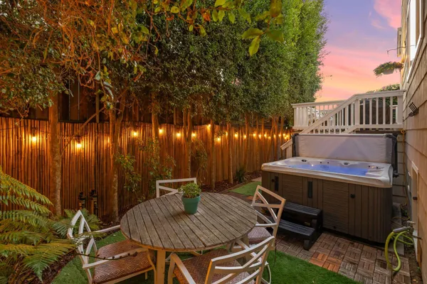 a view of an outdoor sitting area with brick walls
