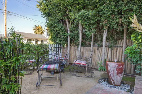 a view of a chairs and table in backyard