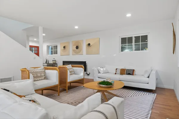 a living room with furniture and wooden floor