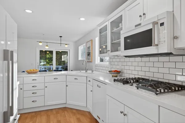 a kitchen with a stove a sink and a microwave