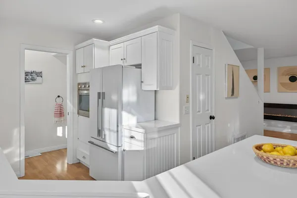 a view of kitchen with stainless steel appliances kitchen island refrigerator and stove