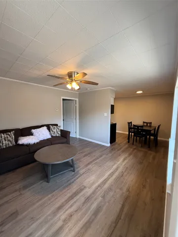 a living room with furniture and a chandelier