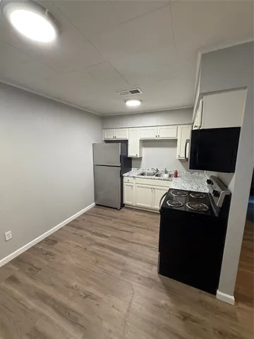 a kitchen with a stove and a refrigerator
