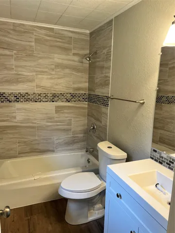 a bathroom with a toilet a sink and bathtub