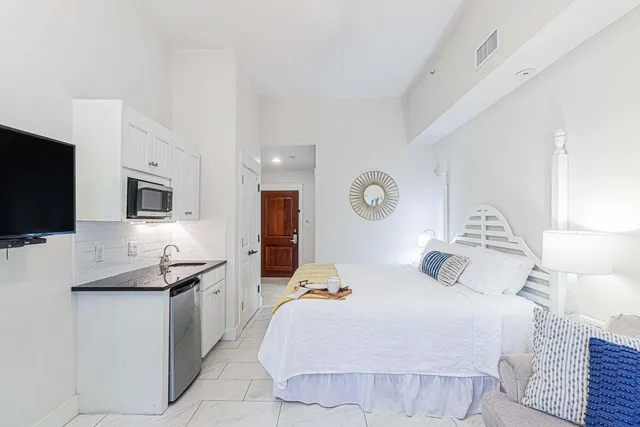 a bedroom with a bed and a flat screen tv