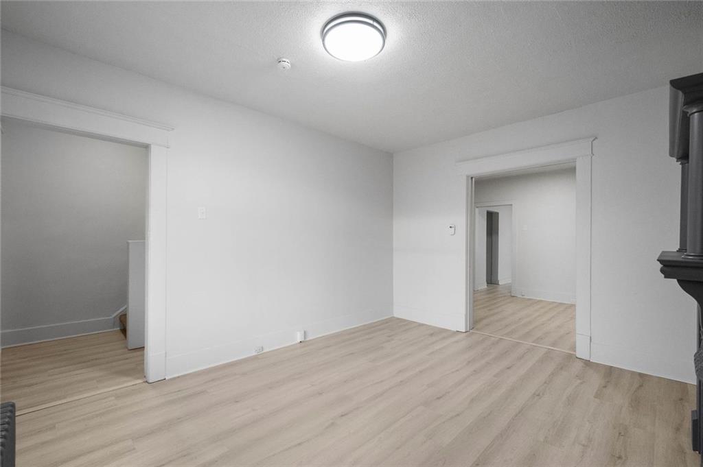 306 Park Road Ambridge, PA 15003 - Photo 3 of 43 an empty room with wooden floor and windows