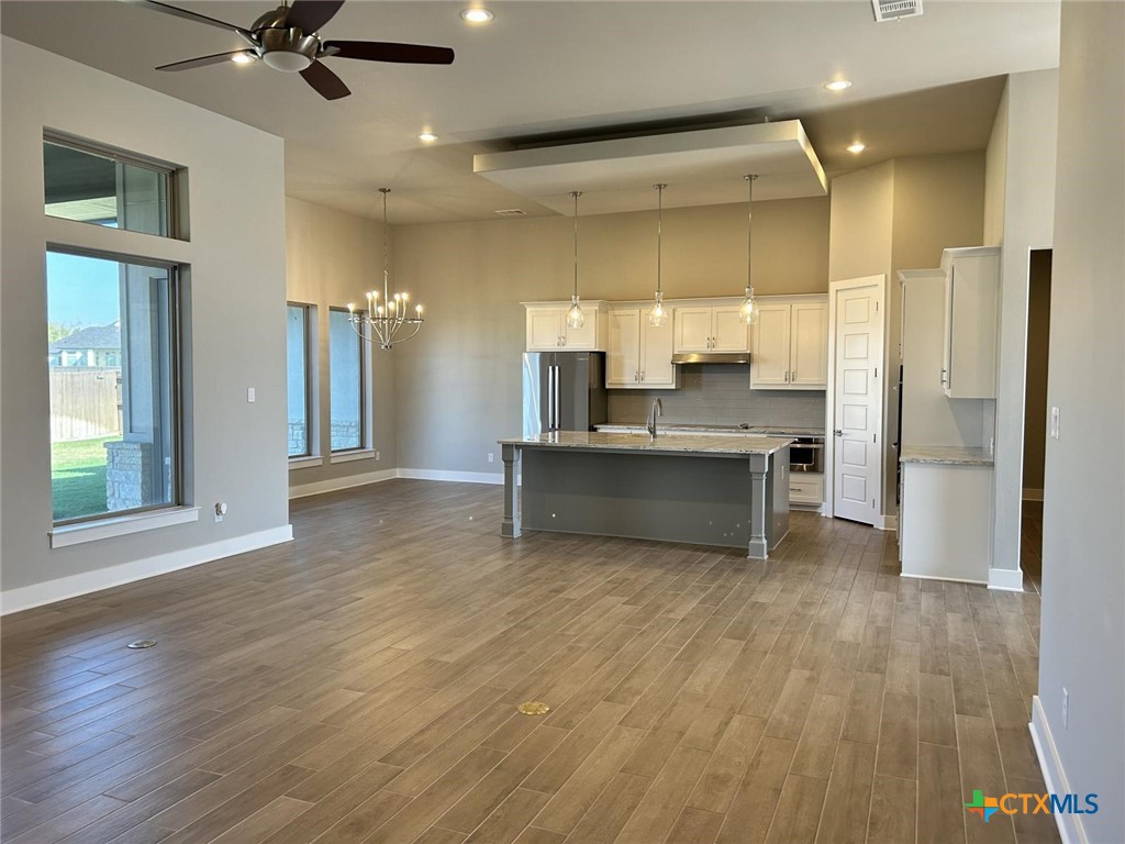 6426 Clayton Court Temple, TX 76502 - Photo 26 of 34 a large kitchen with a refrigerator and a wooden floor