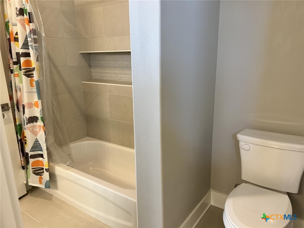 6426 Clayton Court Temple, TX 76502 - Photo 29 of 34 a white toilet sitting next to a bath tub
