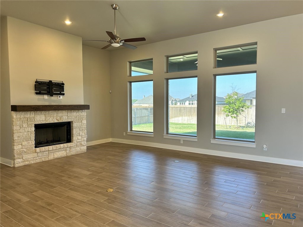 6426 Clayton Court Temple, TX 76502 - Photo 4 of 34 a view of a livingroom with wooden floor a fireplace and windows