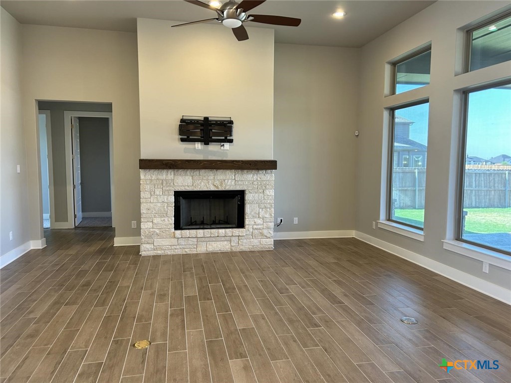 6426 Clayton Court Temple, TX 76502 - Photo 5 of 34 wooden floor fireplace and windows in an empty room