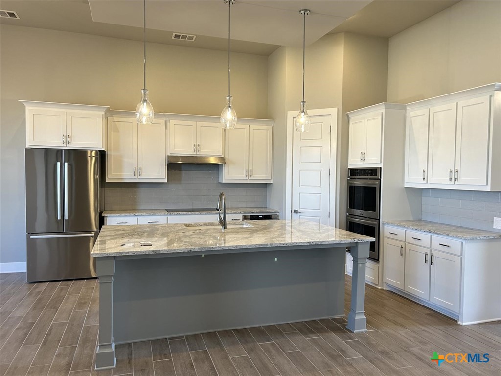 6426 Clayton Court Temple, TX 76502 - Photo 8 of 34 a kitchen with stainless steel appliances granite countertop a sink a stove and a refrigerator