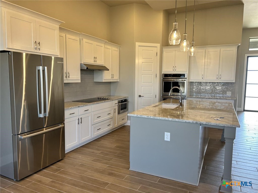 6426 Clayton Court Temple, TX 76502 - Photo 10 of 34 a kitchen with stainless steel appliances granite countertop a refrigerator a sink and a stove