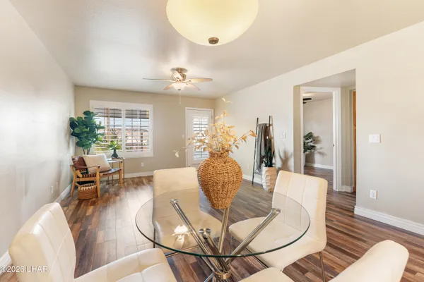 a living room with dining room and wooden floor