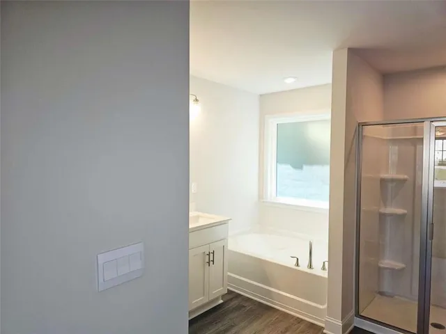 a bathroom with a bathtub and a shower