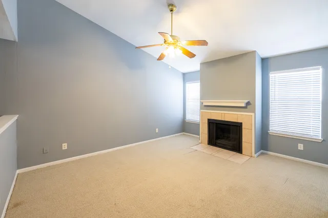 a view of a room with a fireplace and window