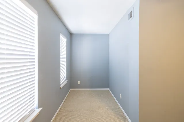 a view of hallway with windows