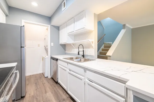 a kitchen with a sink and a refrigerator