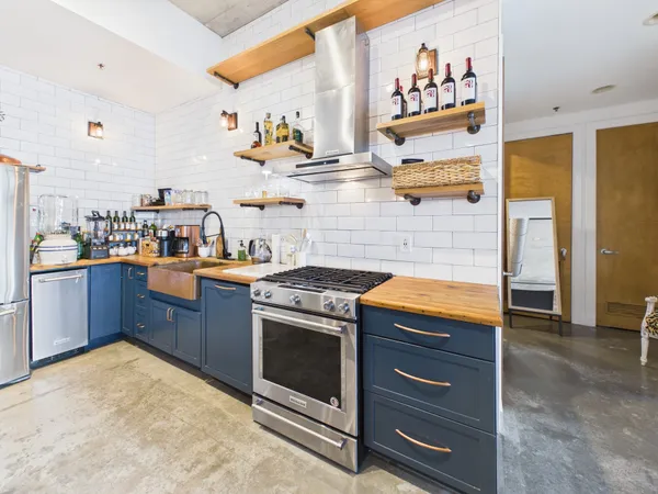 a kitchen with stainless steel appliances granite countertop a stove and a sink