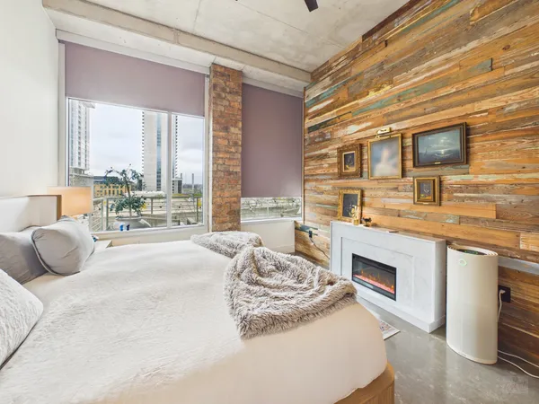 a bedroom with furniture and a flat screen tv