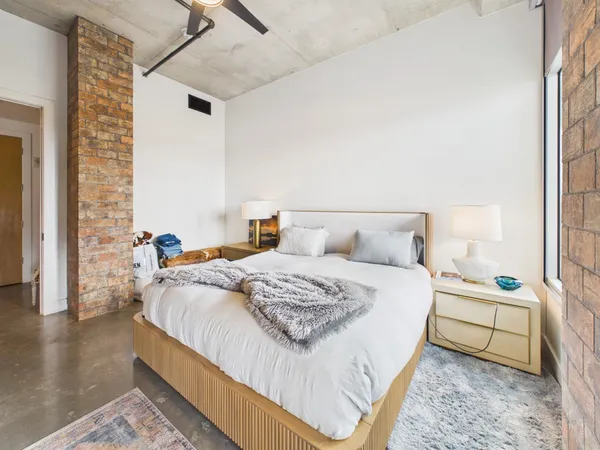 a bedroom with a bed and a table