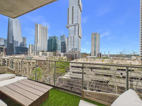a balcony with couch and wooden floor