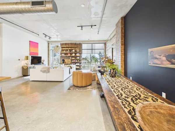 a bedroom with furniture and large windows