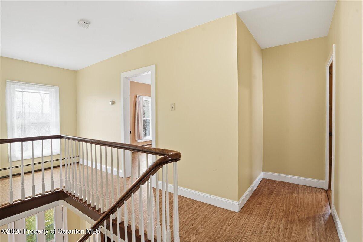795 Wescott Road New Milford, PA 18834 - Photo 42 of 81 a view of a hallway with wooden floor and staircase