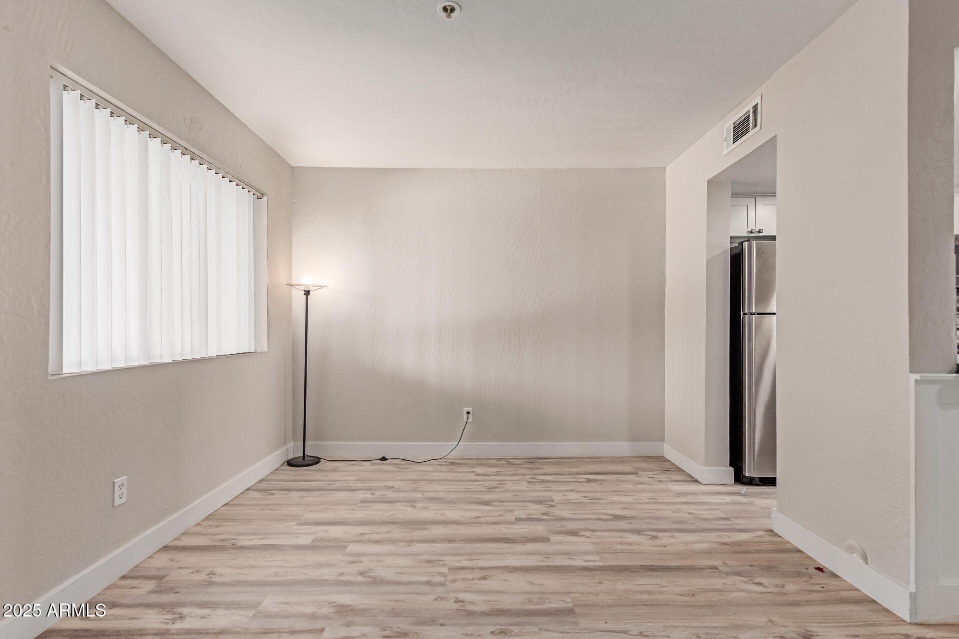 12123 West Bell Road, Unit 138 Surprise, AZ 85378 - Photo 11 of 28 a view of empty room with wooden floor